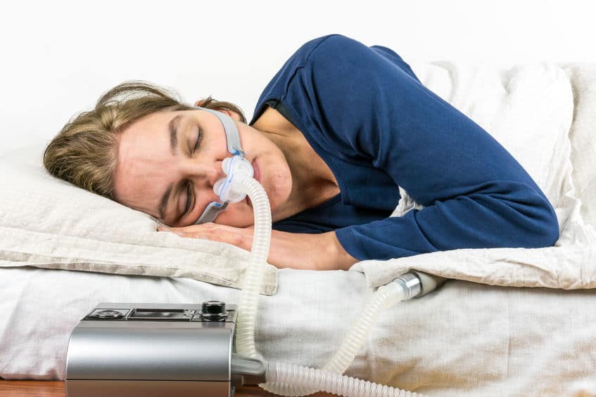 Woman using positive pressure breathing device
